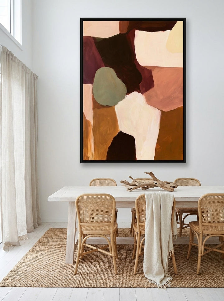 Oversized statement canvas wall art with a black surround styled on the wall in a coastal dining room