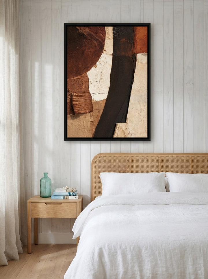 Canvas wall art with a black surround styled on the wall in a coastal bedroom