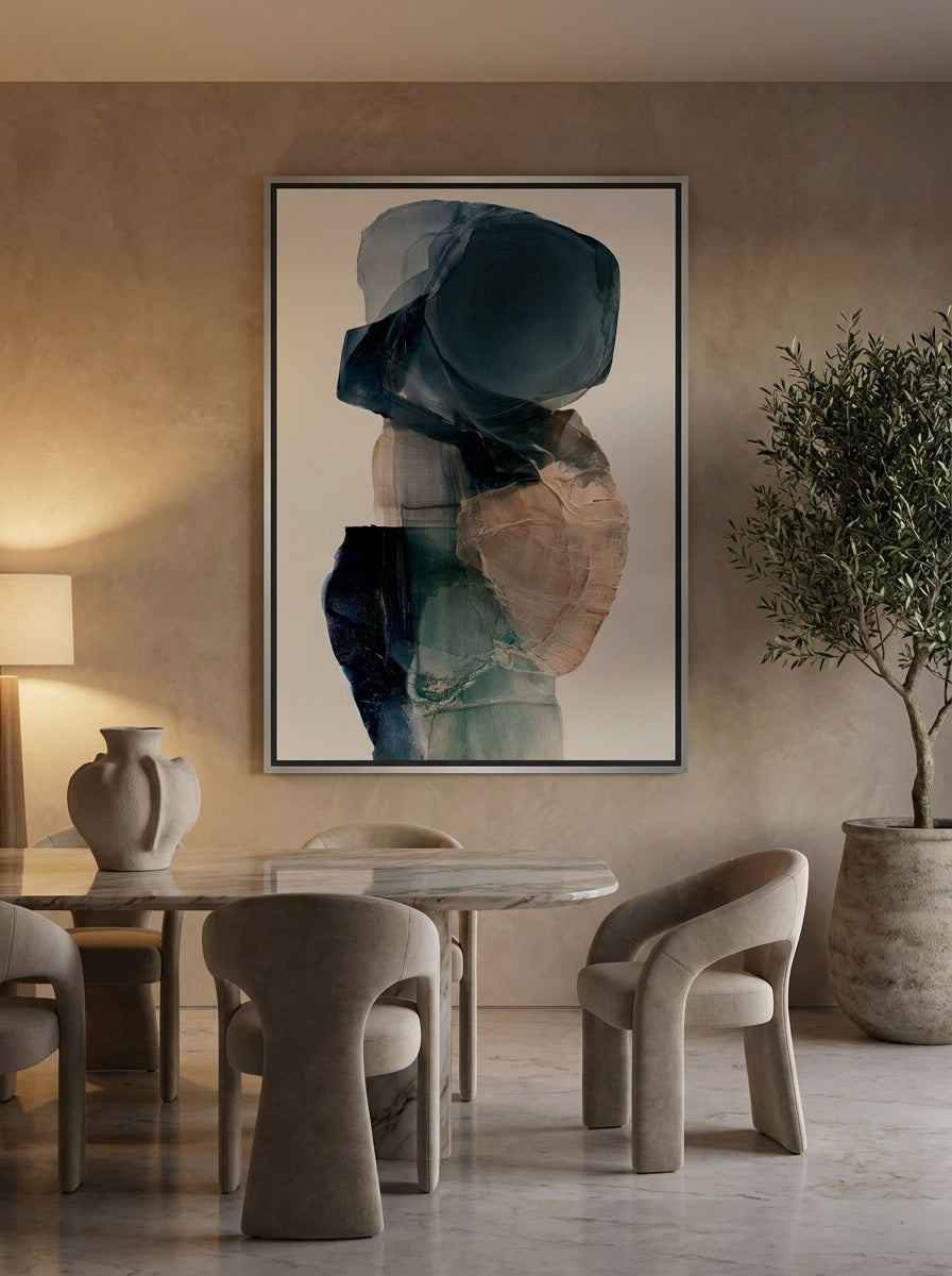 Oversized statement canvas wall art with a silver leaf surround styled on the wall in a luxe dining room