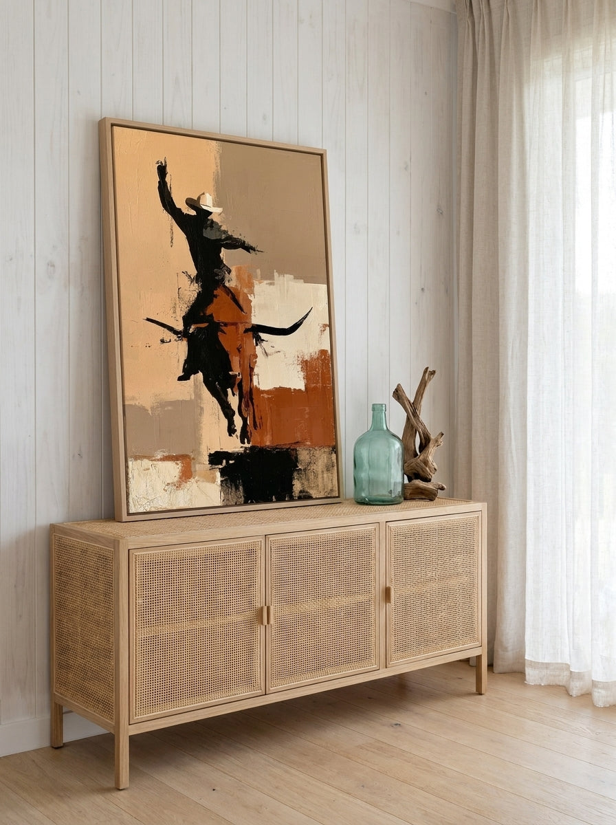 Canvas wall art with a natural timber surround standing on a sideboard in a coastal home office