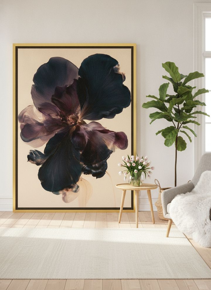 Oversized statement canvas wall art with a gold leaf surround leaning against the wall in a bright Scandinavian living room