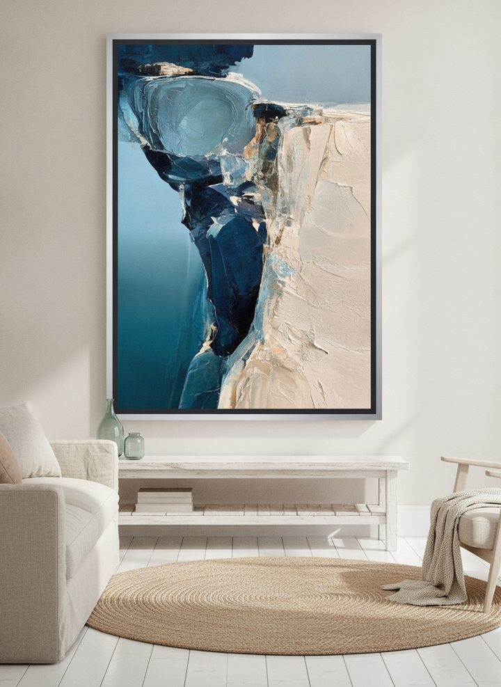 Oversized statement canvas wall art with a silver leaf surround styled on the wall in a coastal living room