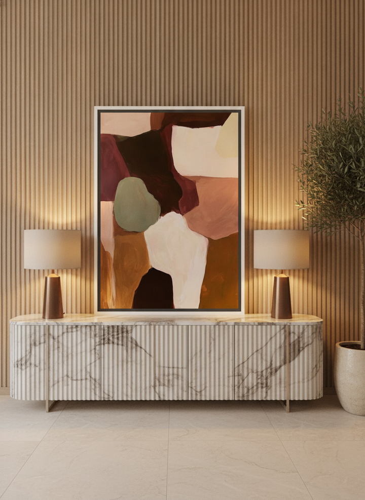 Canvas wall art with a white surround standing on a sideboard in a luxe bedroom