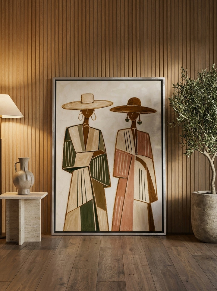 Oversized statement canvas wall art with a silver leaf surround leaning against the wall in a luxe living room