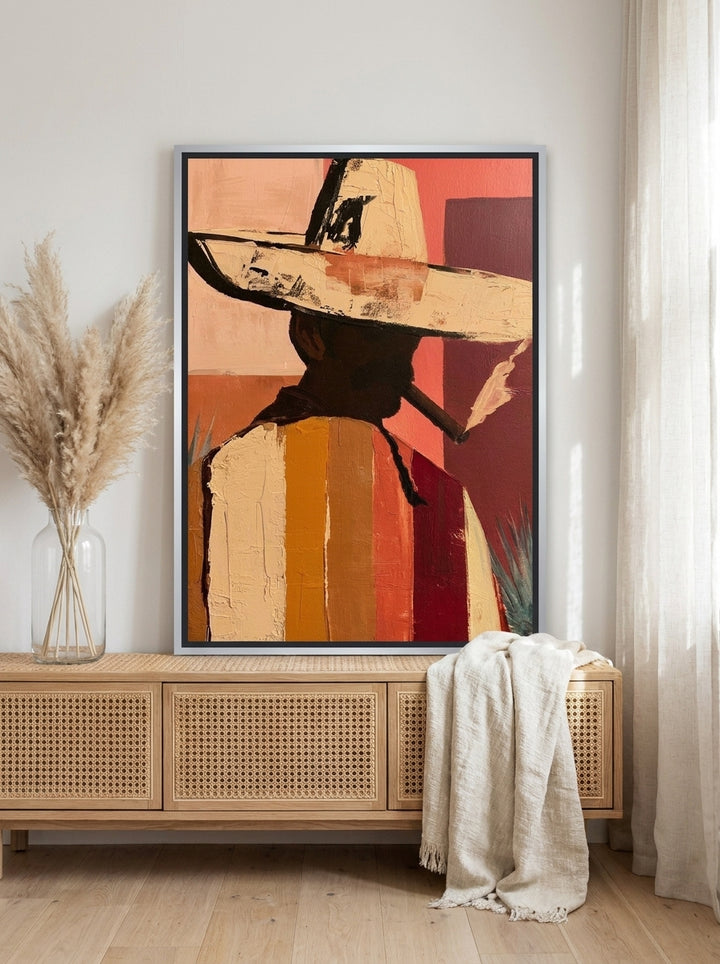 Canvas wall art with a silver leaf surround standing on a sideboard in a coastal home office