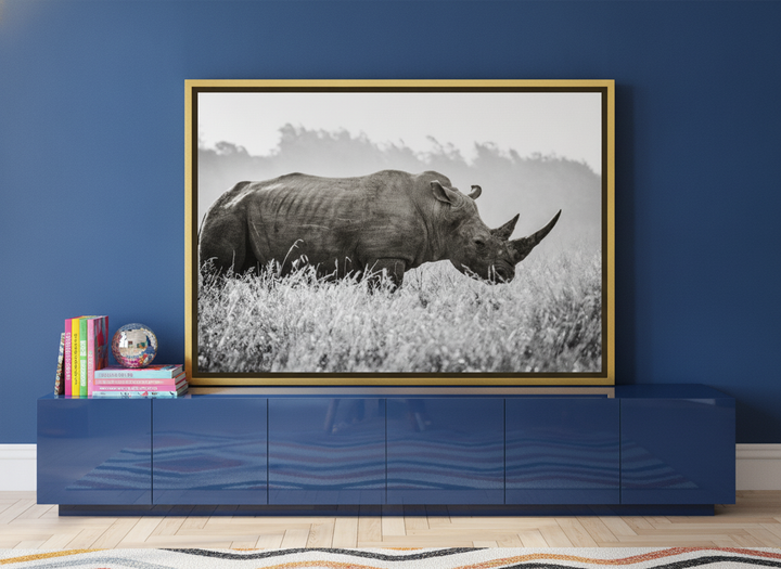 Canvas wall art with a gold leaf surround standing on a sideboard in a colourful eclectic home office