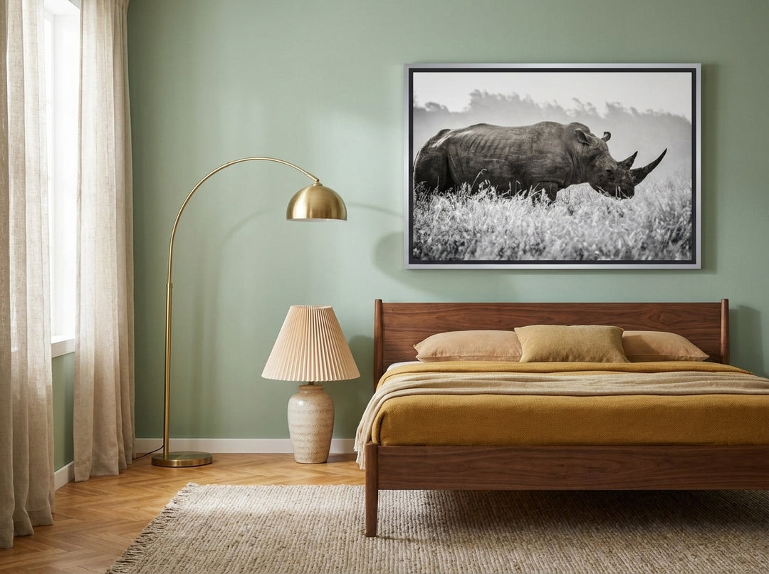 Canvas wall art with a silver leaf surround styled on the wall in a mid-century bedroom