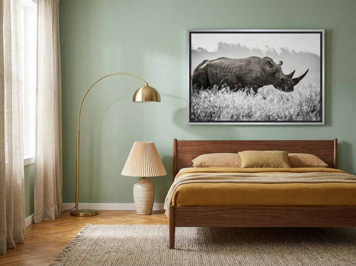 Canvas wall art with a silver leaf surround styled on the wall in a mid-century bedroom
