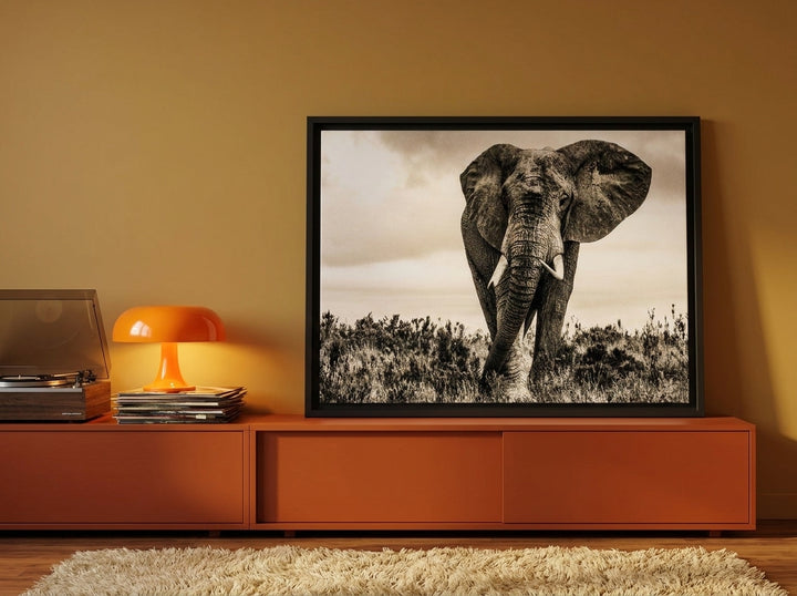Canvas wall art with a black surround standing on a sideboard in a retro 70s bedroom