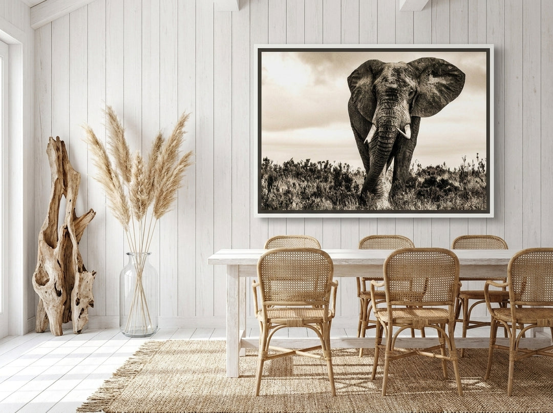 Oversized statement canvas wall art with a white surround styled on the wall in a coastal dining room