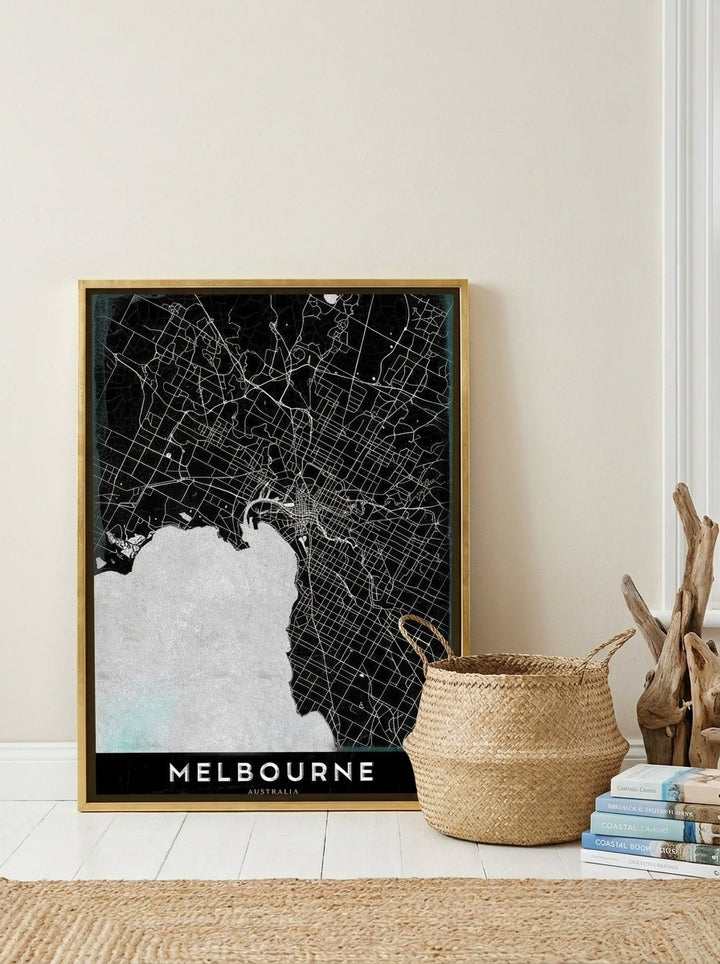 Canvas wall art with a gold leaf surround leaning against the wall in a coastal bedroom