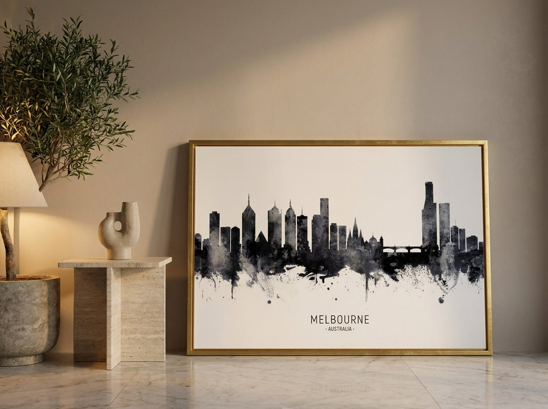Canvas wall art with a gold leaf surround leaning against the wall in a luxe dining room