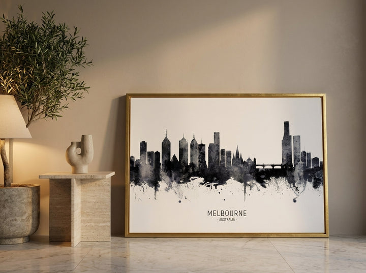 Canvas wall art with a gold leaf surround leaning against the wall in a luxe dining room