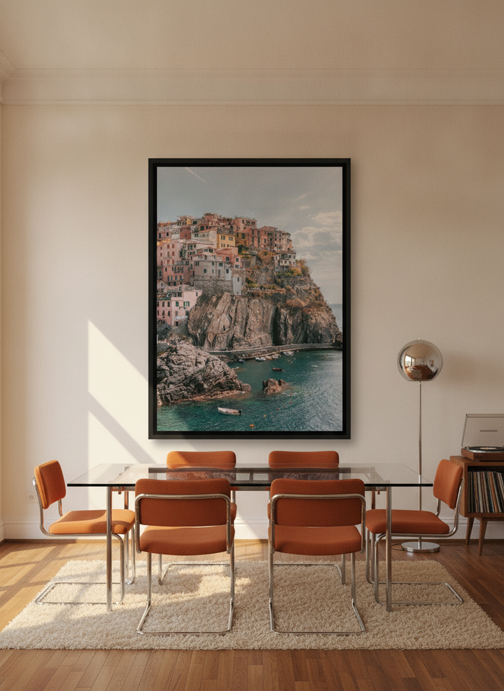Oversized statement canvas wall art with a black surround styled on the wall in a retro 70s dining room