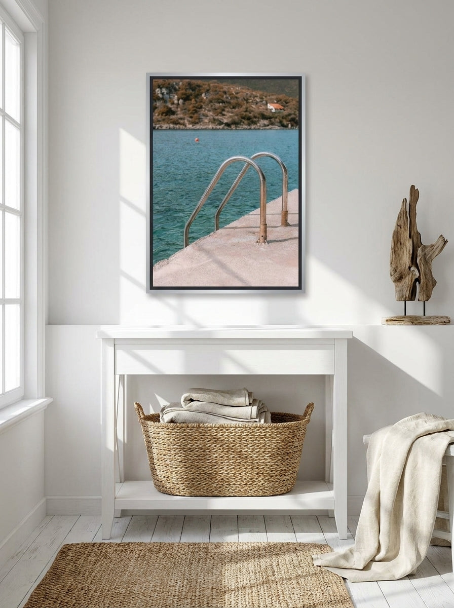 Canvas wall art with a silver leaf surround styled on the wall in a coastal bathroom