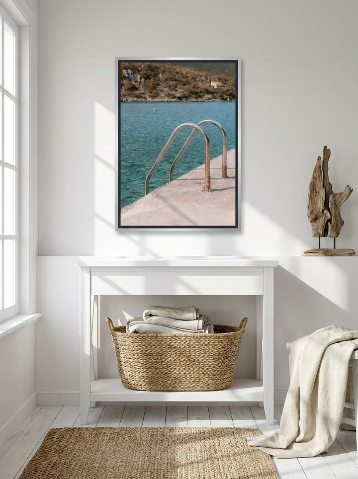 Canvas wall art with a silver leaf surround styled on the wall in a coastal bathroom