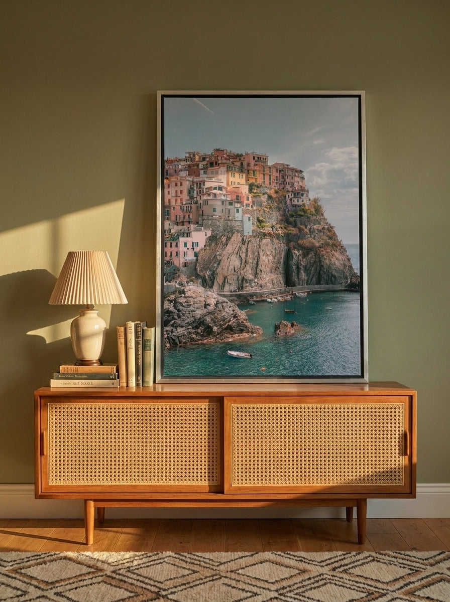 Canvas wall art with a silver leaf surround standing on a sideboard in a mid-century home office