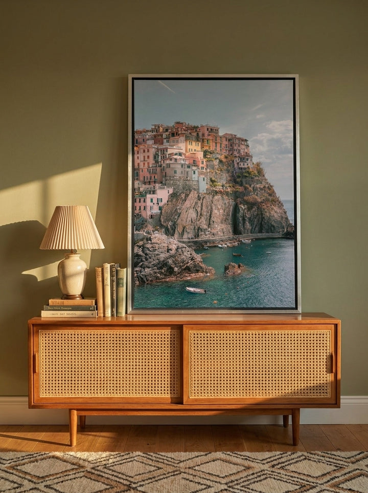 Canvas wall art with a silver leaf surround standing on a sideboard in a mid-century home office