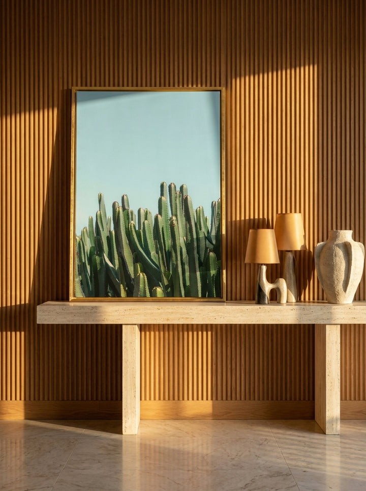 Canvas wall art with a gold leaf surround standing on a console in a luxe home office
