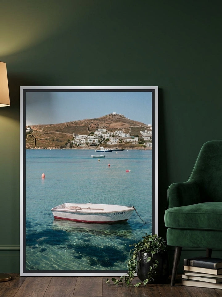 Canvas wall art with a silver leaf surround leaning against the wall in a moody home office
