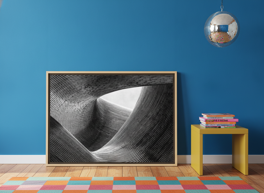 Oversized statement canvas wall art with a natural timber surround leaning against the wall in a colourful eclectic living room