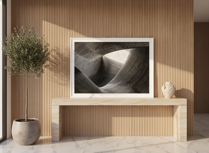 Modern wall art print standing on a console in a luxe dining room