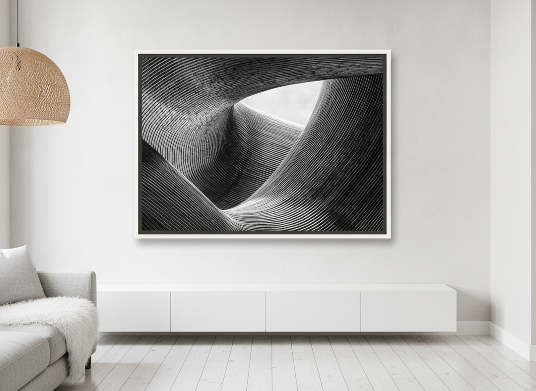Oversized statement canvas wall art with a white surround styled on the wall in a bright Scandinavian living room