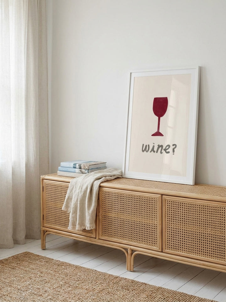 Modern wall art print standing on a sideboard in a coastal living room