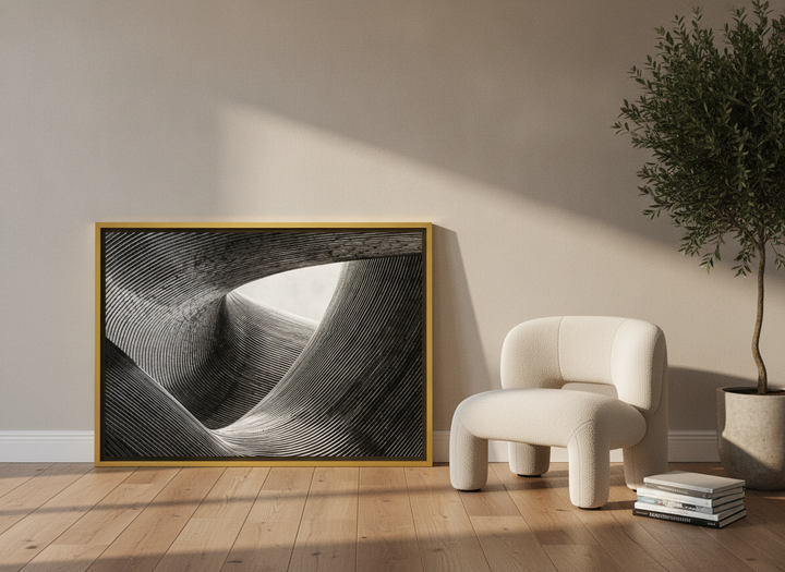 Canvas wall art with a gold leaf surround leaning against the wall in a luxe bedroom