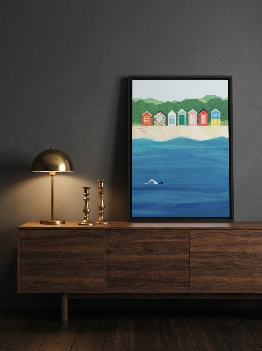 Canvas wall art with a black surround standing on a sideboard in a moody bedroom