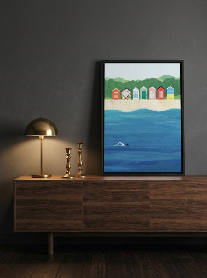 Canvas wall art with a black surround standing on a sideboard in a moody bedroom