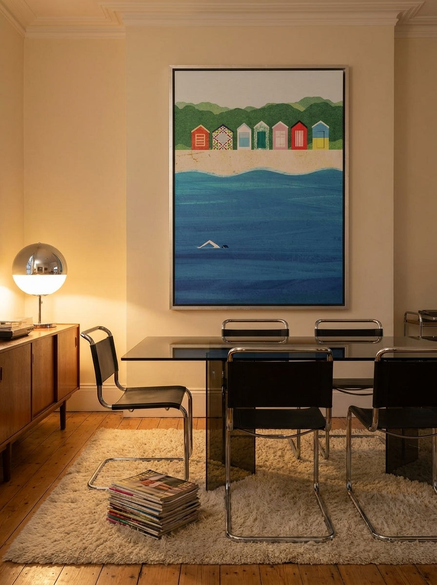 Oversized statement canvas wall art with a silver leaf surround styled on the wall in a retro 70s dining room