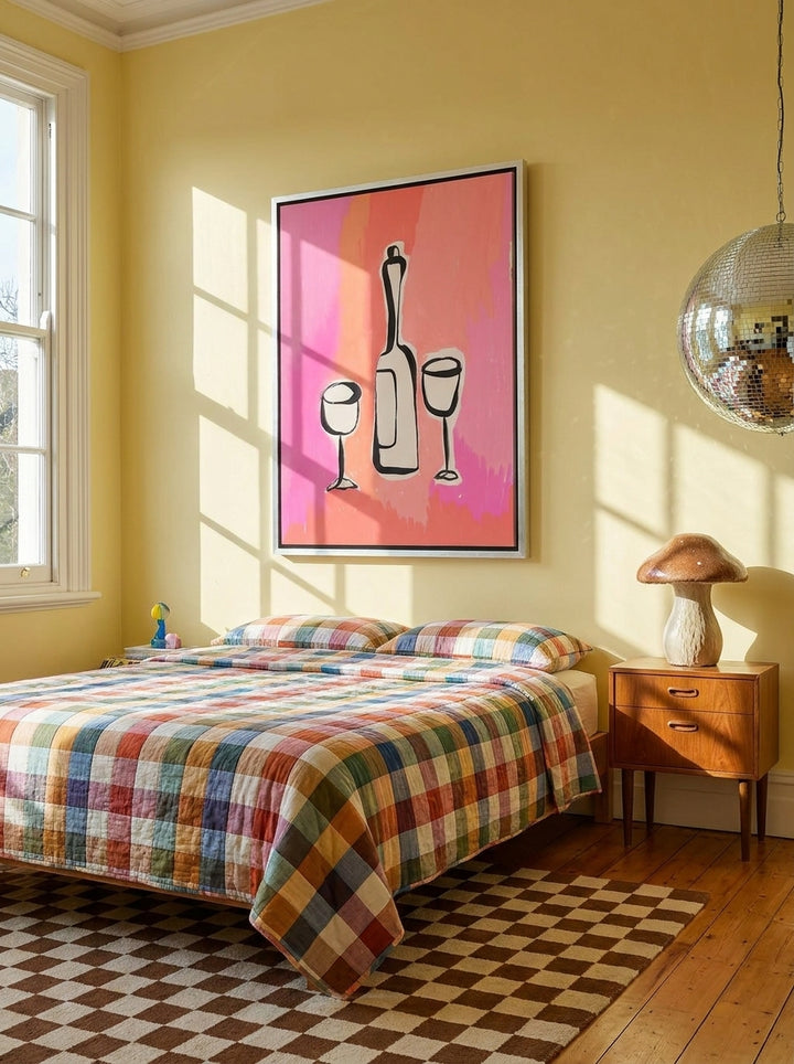 Canvas wall art with a silver leaf surround styled on the wall in a colourful eclectic bedroom