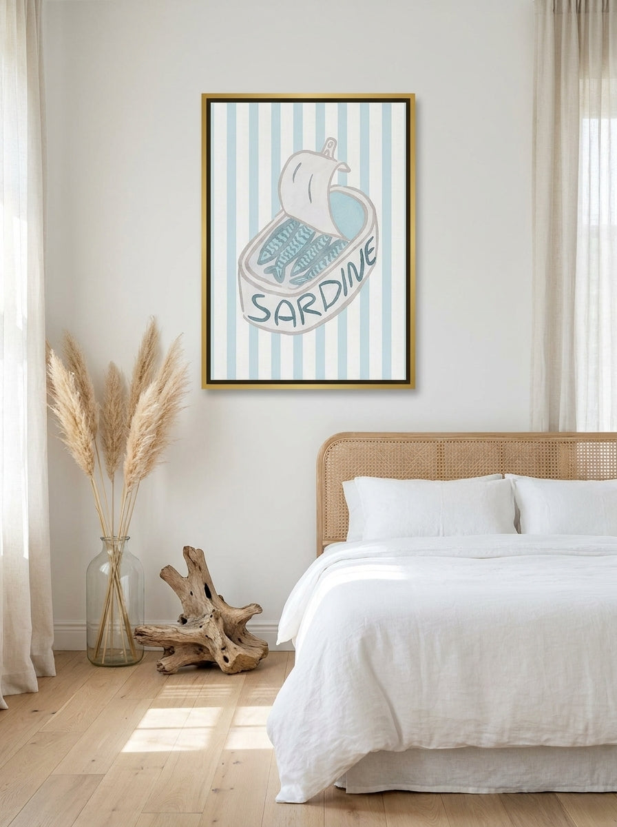Canvas wall art with a gold leaf surround styled on the wall in a coastal bedroom