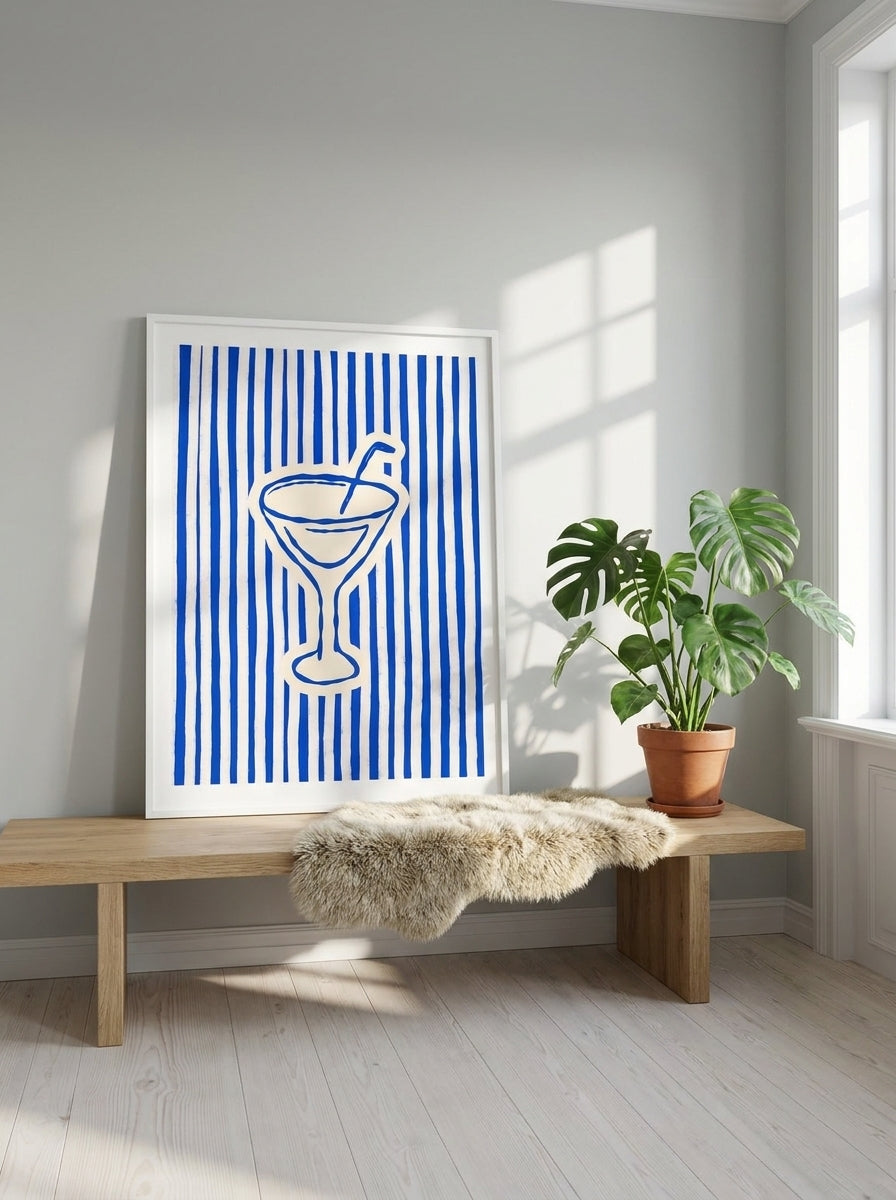 Modern wall art print standing on a bench in a bright Scandinavian living room