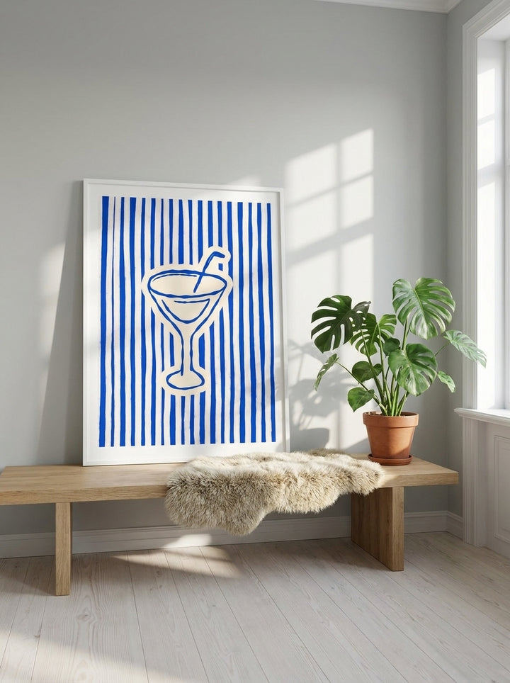 Modern wall art print standing on a bench in a bright Scandinavian living room