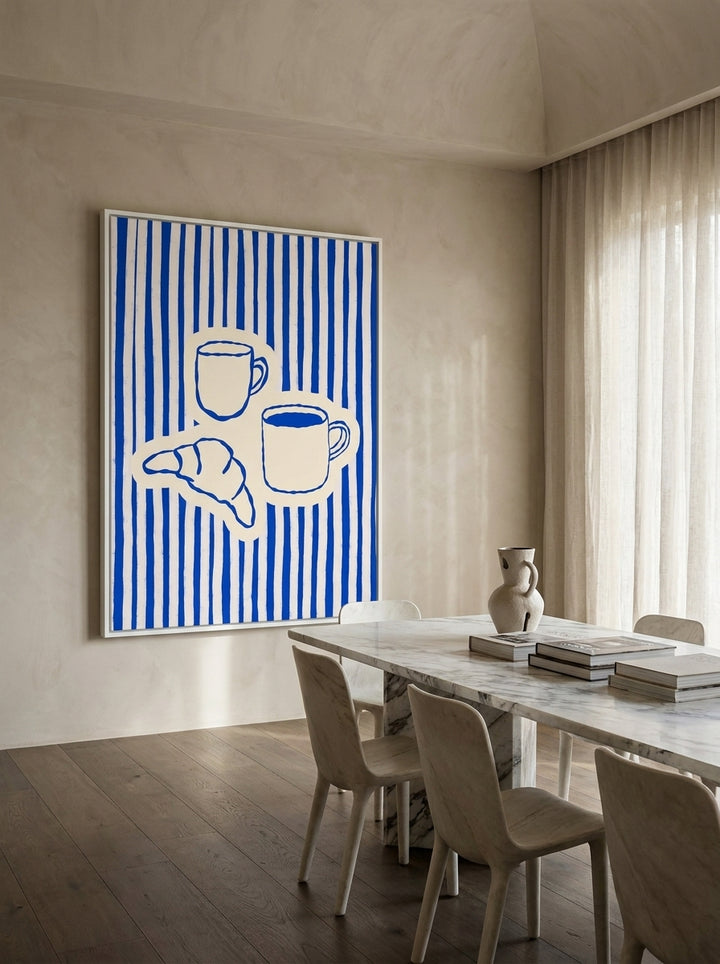Oversized statement canvas wall art with a white surround styled on the wall in a luxe dining room
