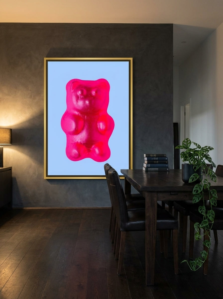 Oversized statement canvas wall art with a gold leaf surround styled on the wall in a moody dining room