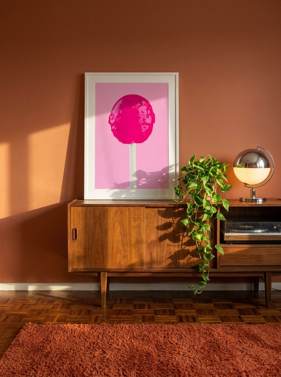 Modern wall art print standing on a sideboard in a retro 70s bedroom