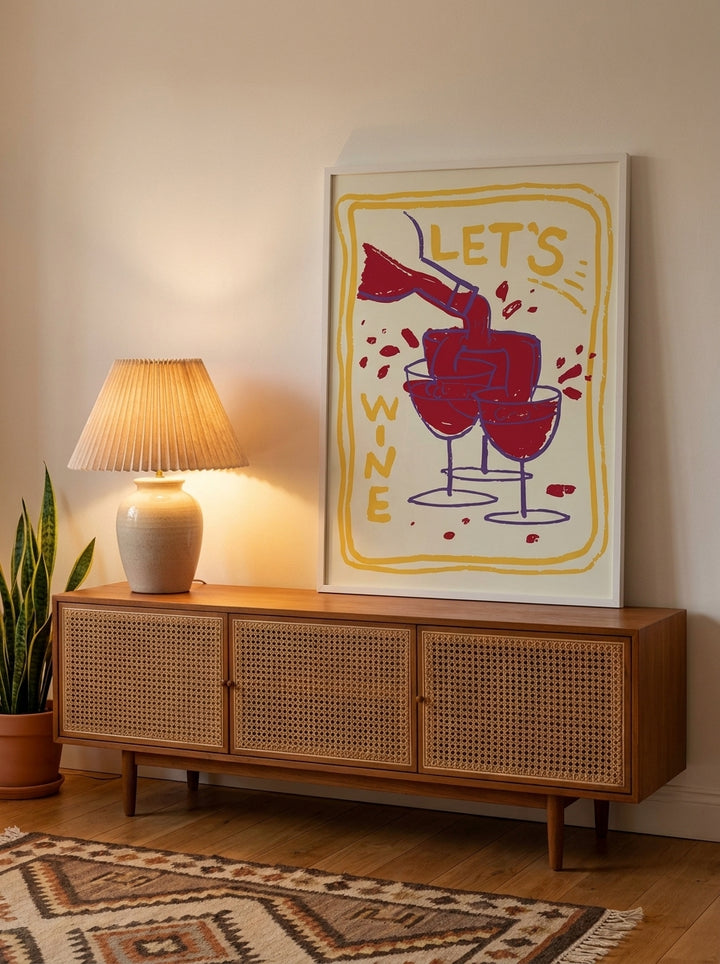 Modern wall art print standing on a sideboard in a mid-century living room