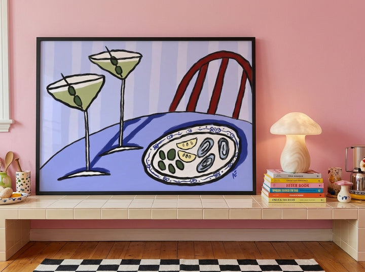 Modern wall art print standing on a kitchen bench in a colourful eclectic kitchen