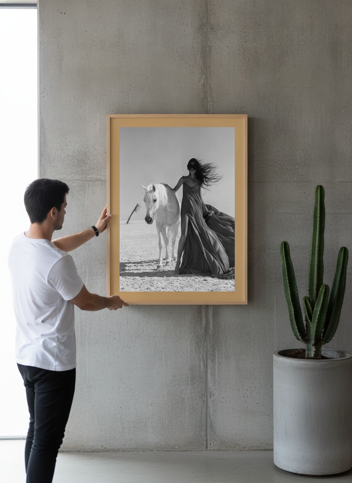 Person holding modern wall art print in an industrial loft living room