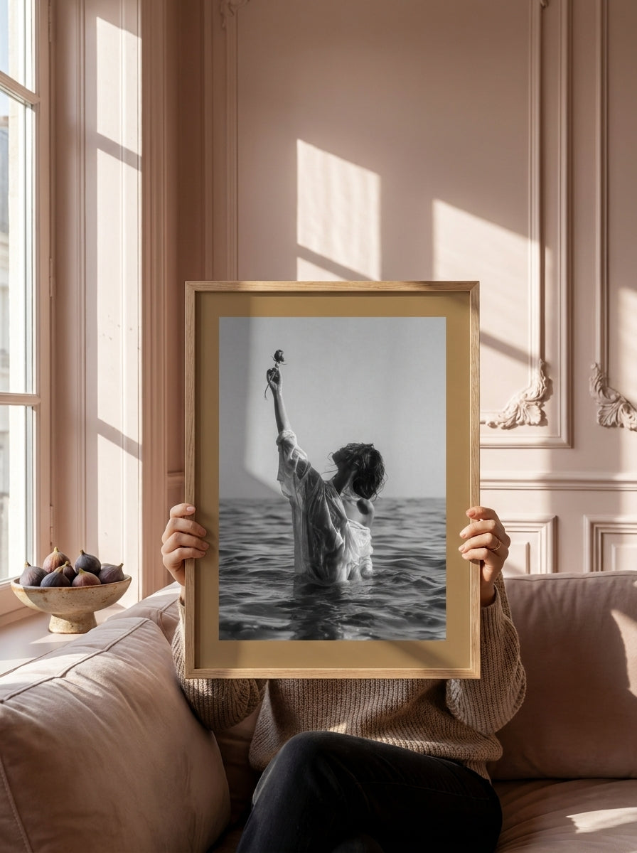 Person holding modern wall art print in a Parisian living room