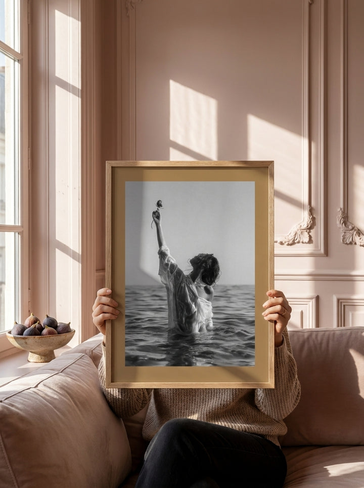 Person holding modern wall art print in a Parisian living room