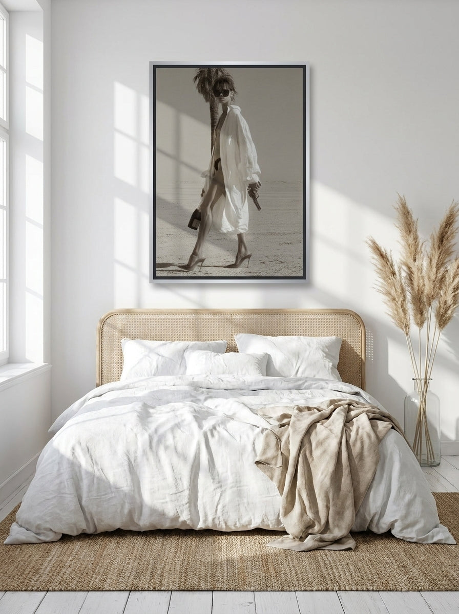 Canvas wall art with a silver leaf surround styled on the wall in a coastal bedroom