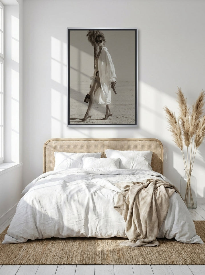 Canvas wall art with a silver leaf surround styled on the wall in a coastal bedroom