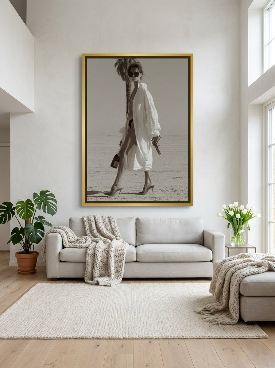 Oversized statement canvas wall art with a gold leaf surround styled on the wall in a bright Scandinavian living room
