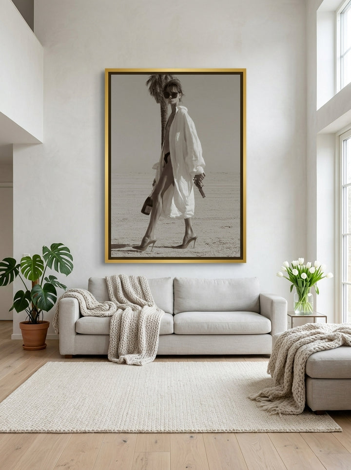 Oversized statement canvas wall art with a gold leaf surround styled on the wall in a bright Scandinavian living room