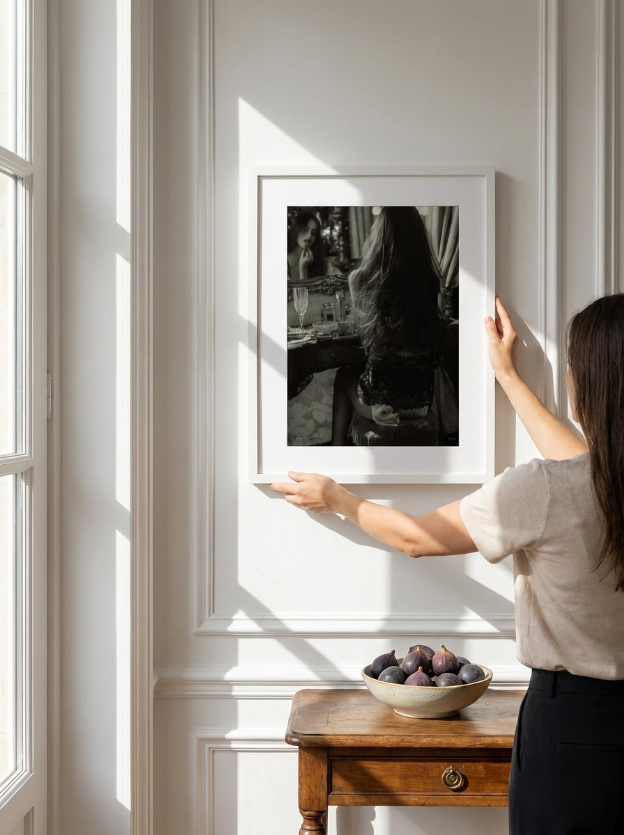 Person holding modern wall art print in a Parisian living room