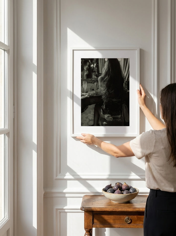 Person holding modern wall art print in a Parisian living room